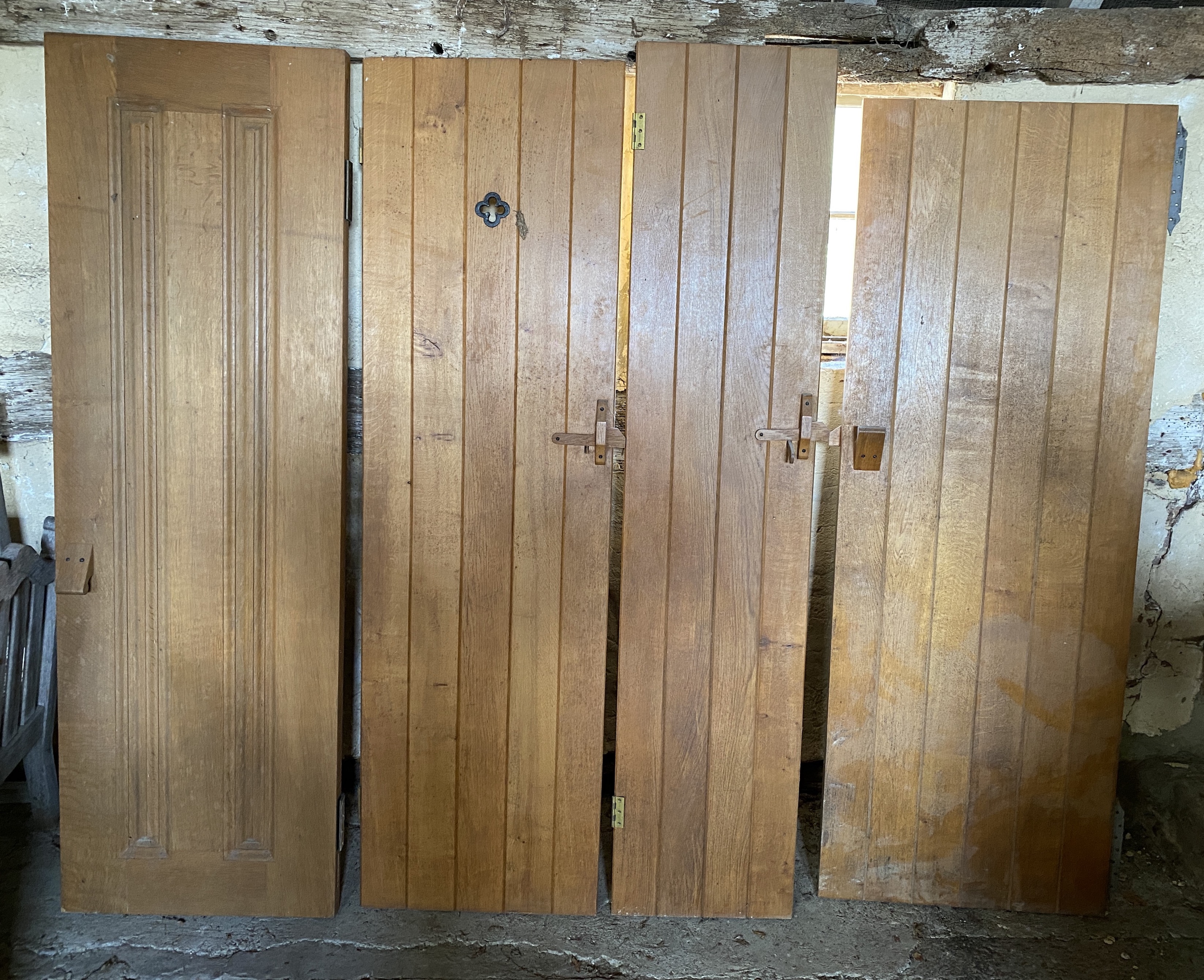 Three solid oak ledged and braced doors, 210 x 58.5cm; 204 x 44.5cm and 95 x 72cm, and a double sided panelled solid oak door, 200 x 64cm (4)